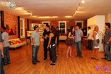 Art lovers gather to admire this First Friday's art exhibit at the Loading Zone