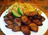 (L to R): Ripe apple banana, ripe plantain banana, and back tostones made from unripe green plantain smashed and fried.<br> <br >Plantain, or platano, is a type of banana that was one of the staples brought from West Africa to Cuba along with okra and yams.